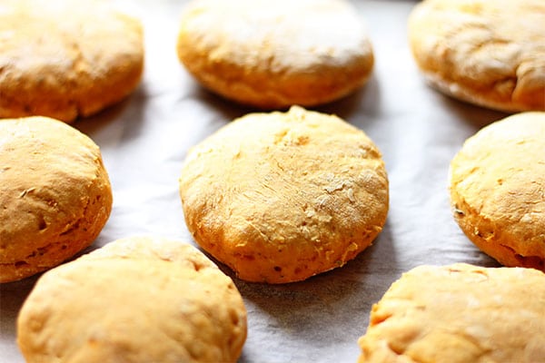 baked sweet potato biscuits on tray lined with parchment paper.
