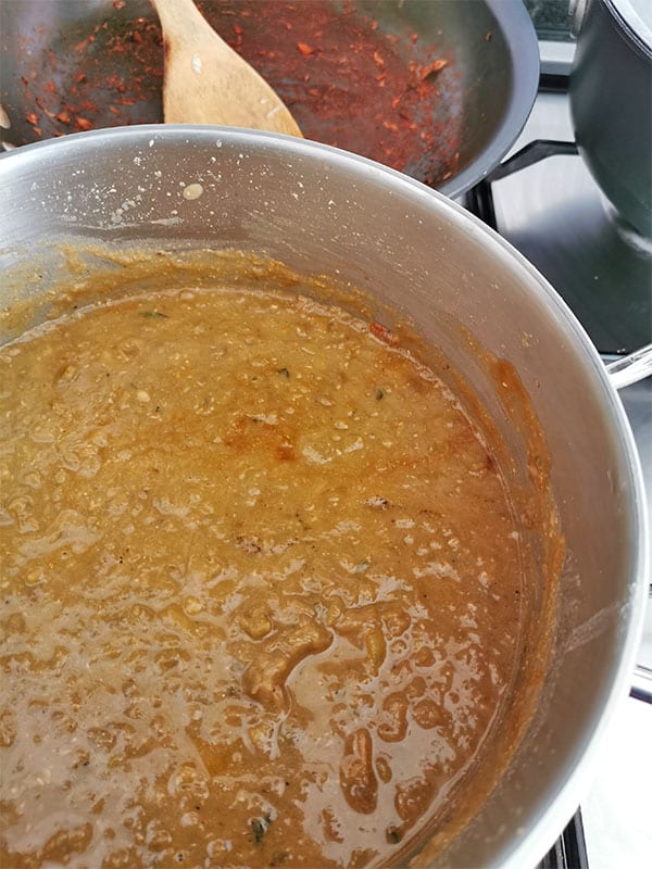 lentil gravy made with cooked and pureed brown lentils in stainless steel pot.