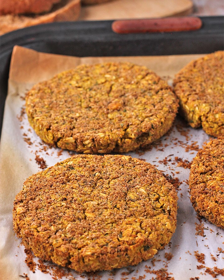 Baked chickpea burgers on baking tray.