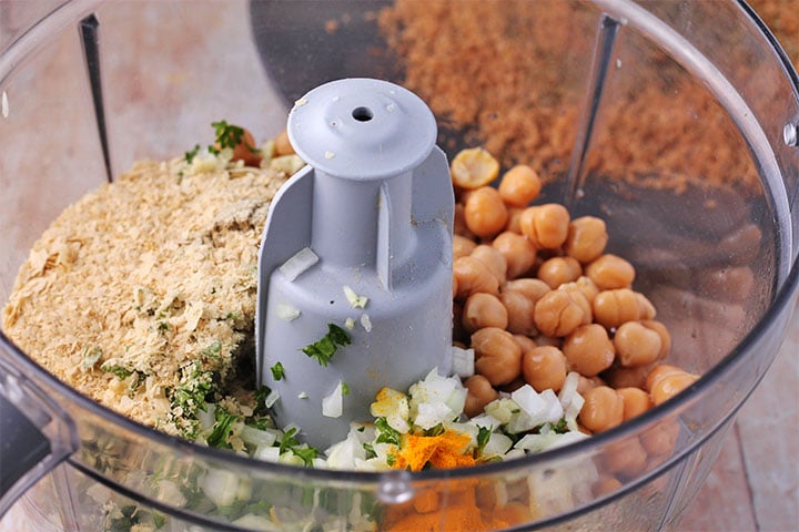Ingredients for baked chickpea burgers in food processor.