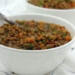 Vegan French lentil soup in 2 white bowls with spoons