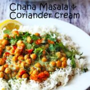 Chana Masala with coriander cream and white rice on white plate