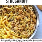 tempeh mushroom stroganoff in steel pan with noodles and text overlay with recipe title, plant-based, oil free and website name.