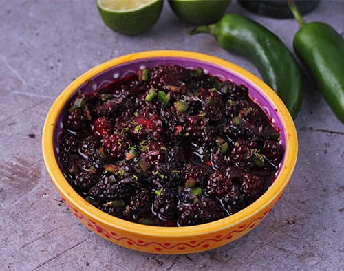 salsa made with blackberries and chopped jalapenos in yellow dish