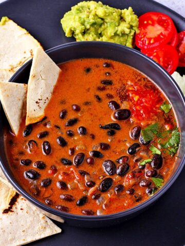 overhead of saucy chipotle black beans in coconut milk sauce