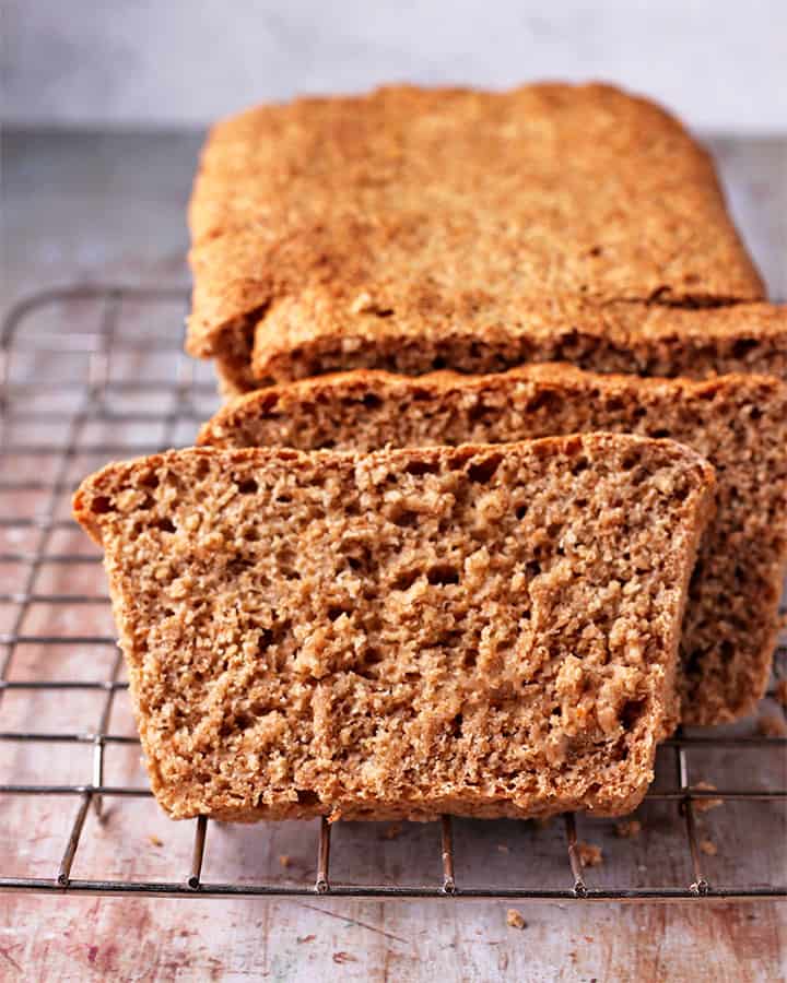 front view of plant-based whole wheat bread with loaf on wire rack