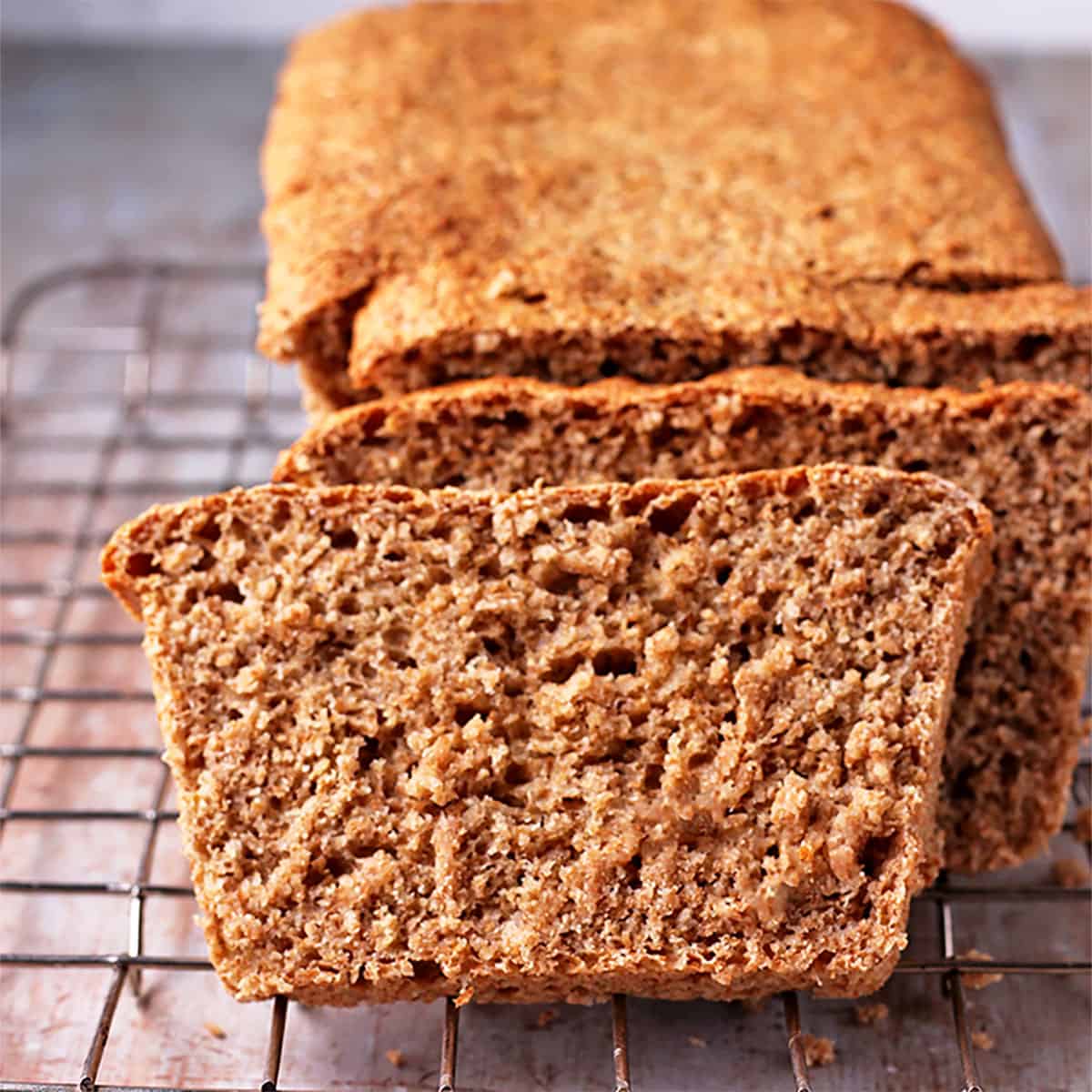front view of plant-based whole wheat bread with loaf on wire rack