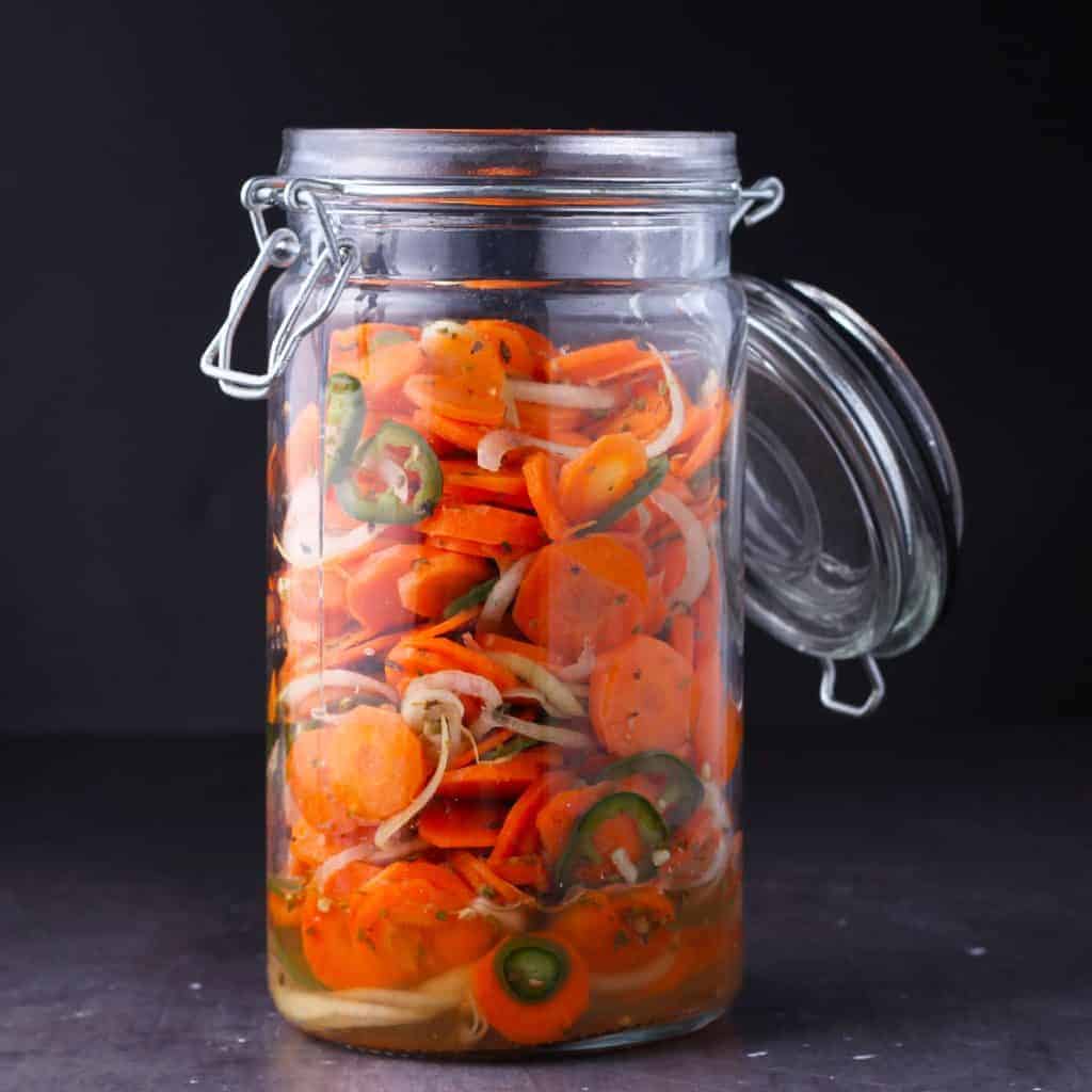 pickled carrots, onions and jalapenos in glass jar