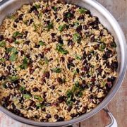 beans and rice with chopped cilantro in stainless steel skillet