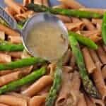 Tarragon sauce is ladled over whole wheat penne pasta and asparagus tips.