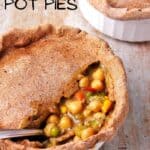 vegan pot pies with whole wheat crust in a white dish with a spoon.