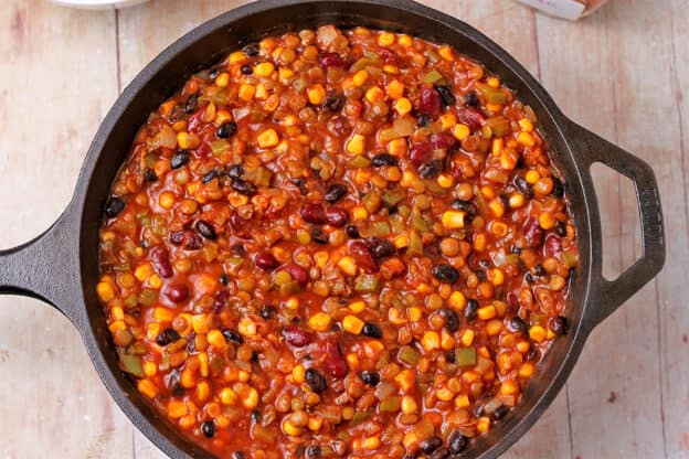The filling for vegan tamale pie is made with lentils, kidney beans, black beans, corn, green pepper, onions, and tomato sauce.
