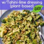 Broccoli slaw with peanuts and dressing on a blue plate with text overlay with recipe title.