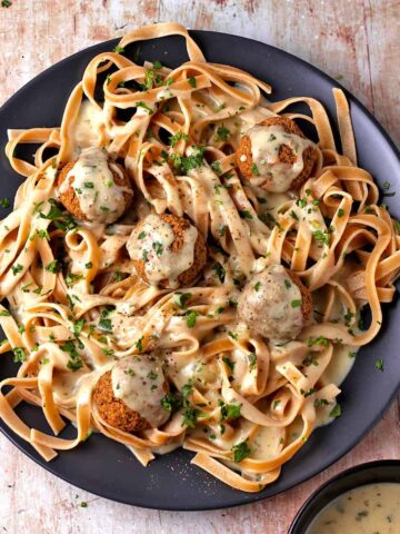 vegan Swedish meatballs and gravy with pasta on a plate.