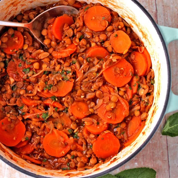 A pot filled with carrot and lentil stew.