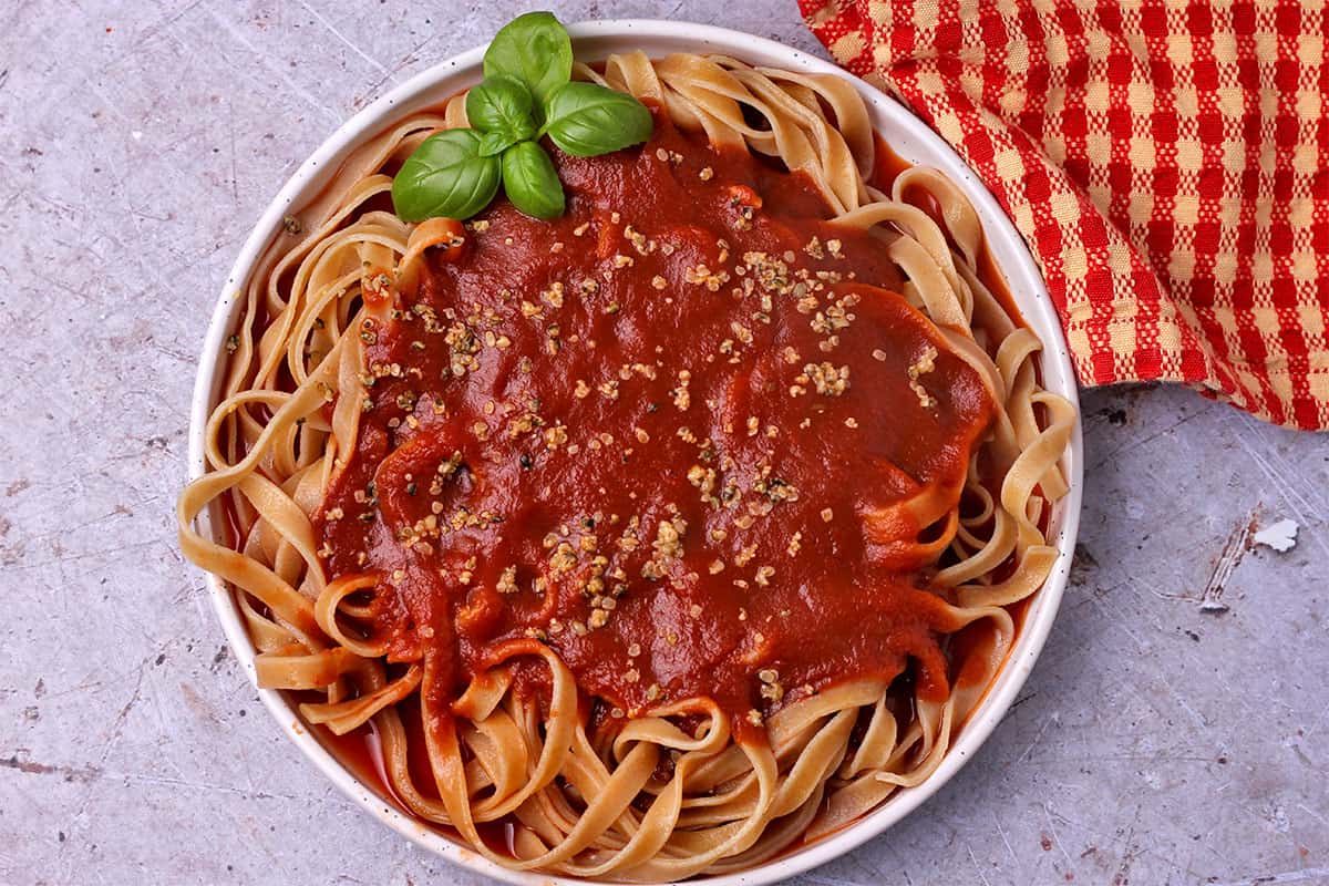 Tomato sauce with pasta and vegan parmesan.