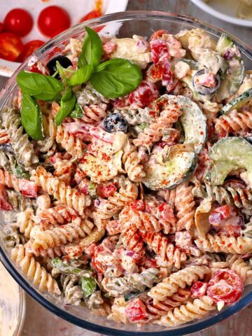A bowl filled with creamy Italian pasta salad.