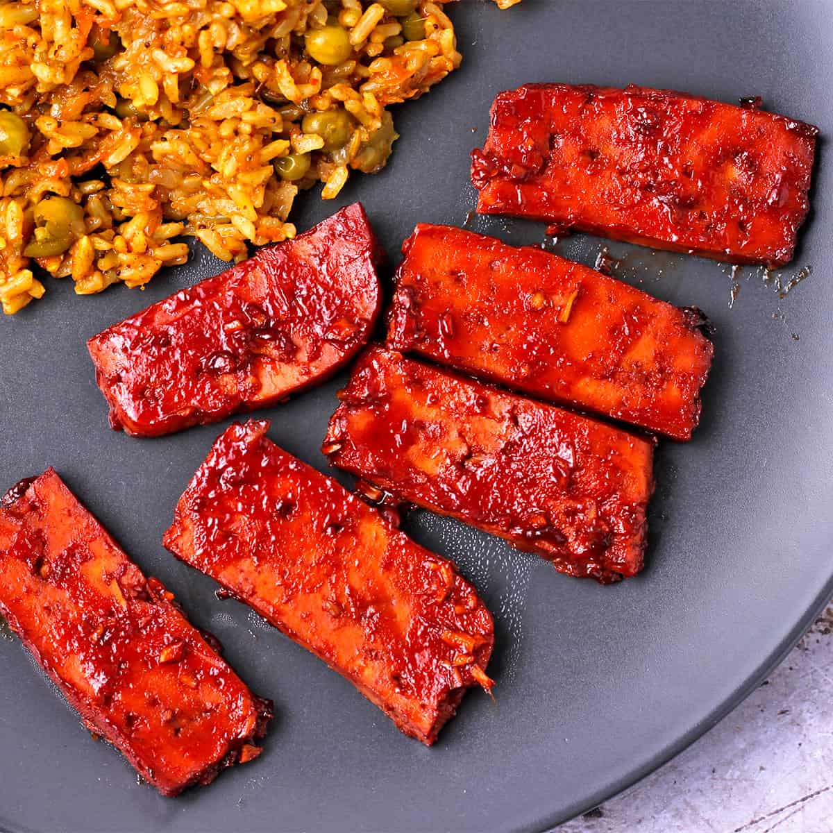 Tofu on a plate with Huli Huli sauce.