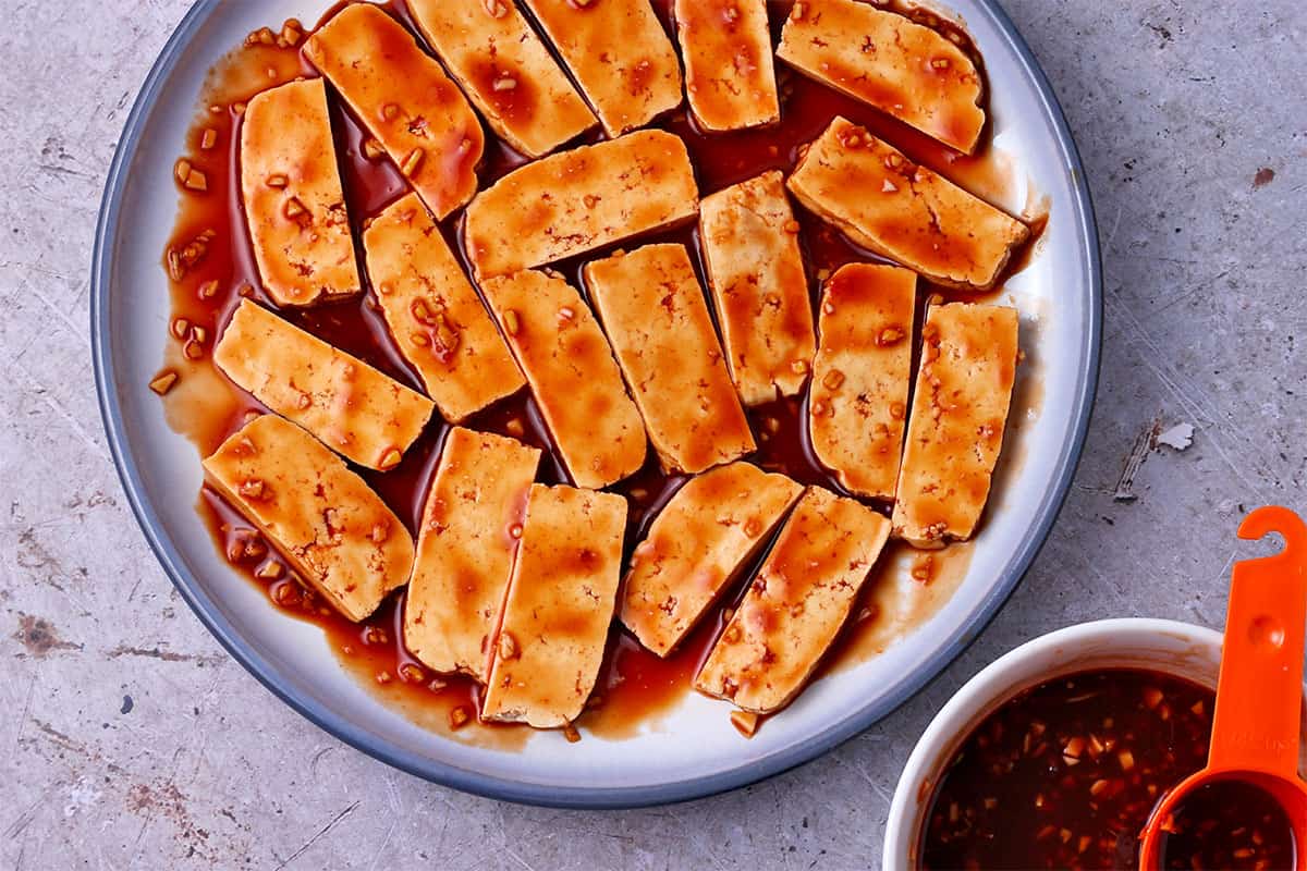 Tofu is marinated in sauce.