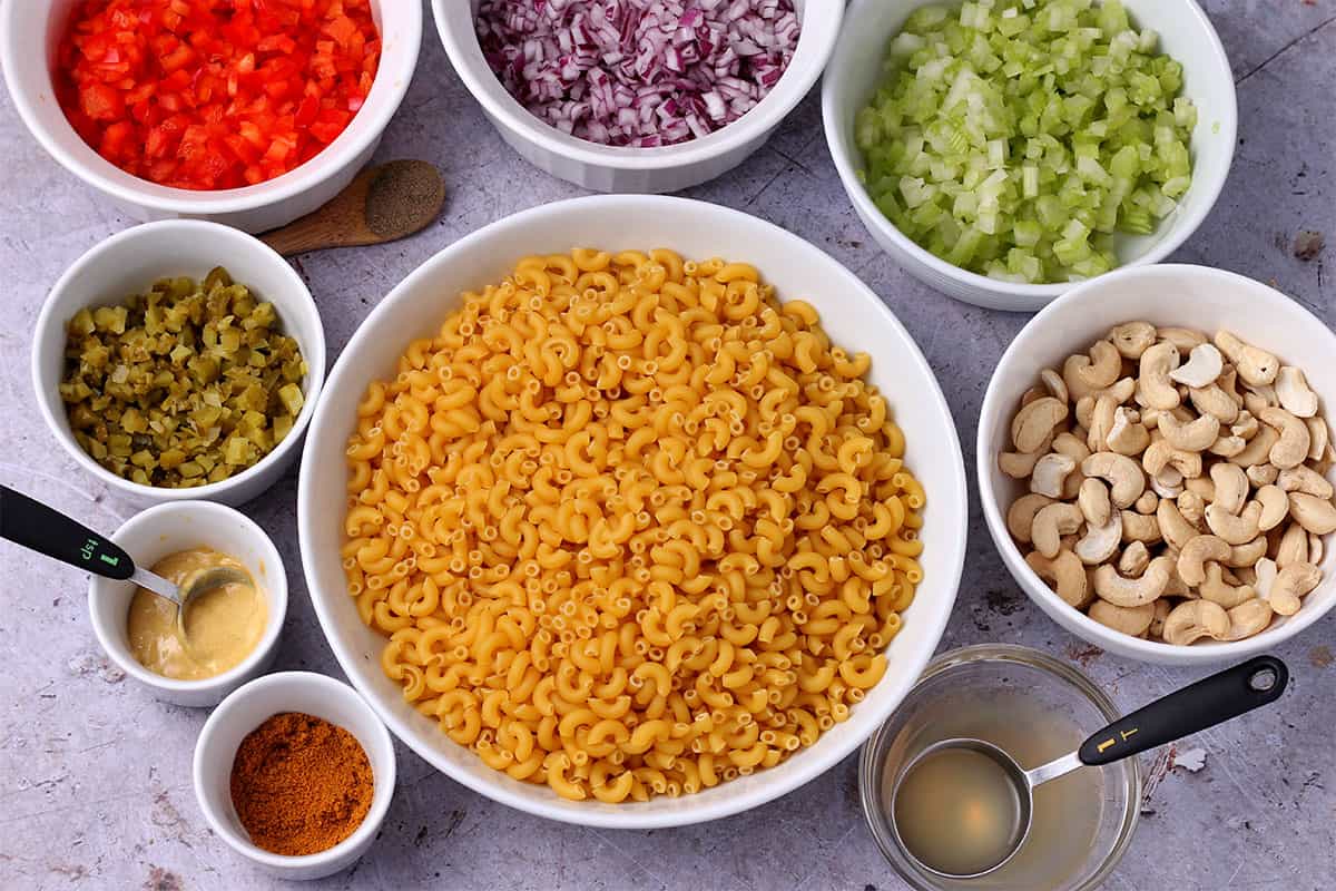 The ingredients for curried macaroni salad in bowls.