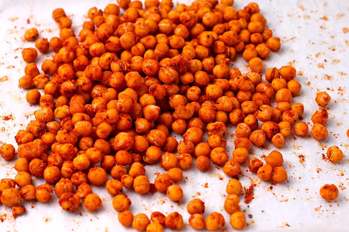 Spicy roasted chickpeas on parchment paper.