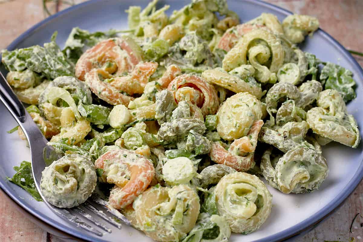 A plate of pasta salad with green goddess dressing.