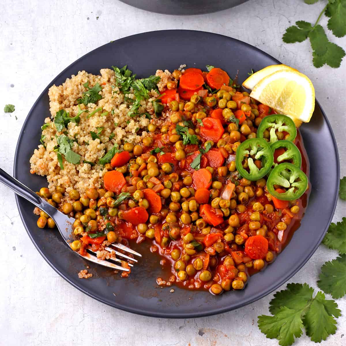 Pea stew on a plate with cooked quinoa..