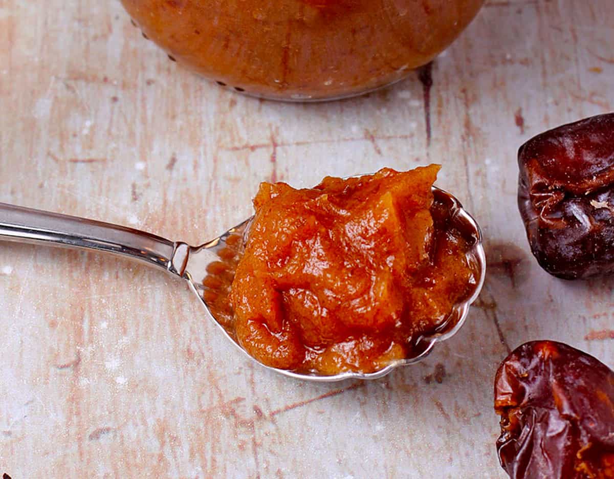 A spoonful of date paste on a board.