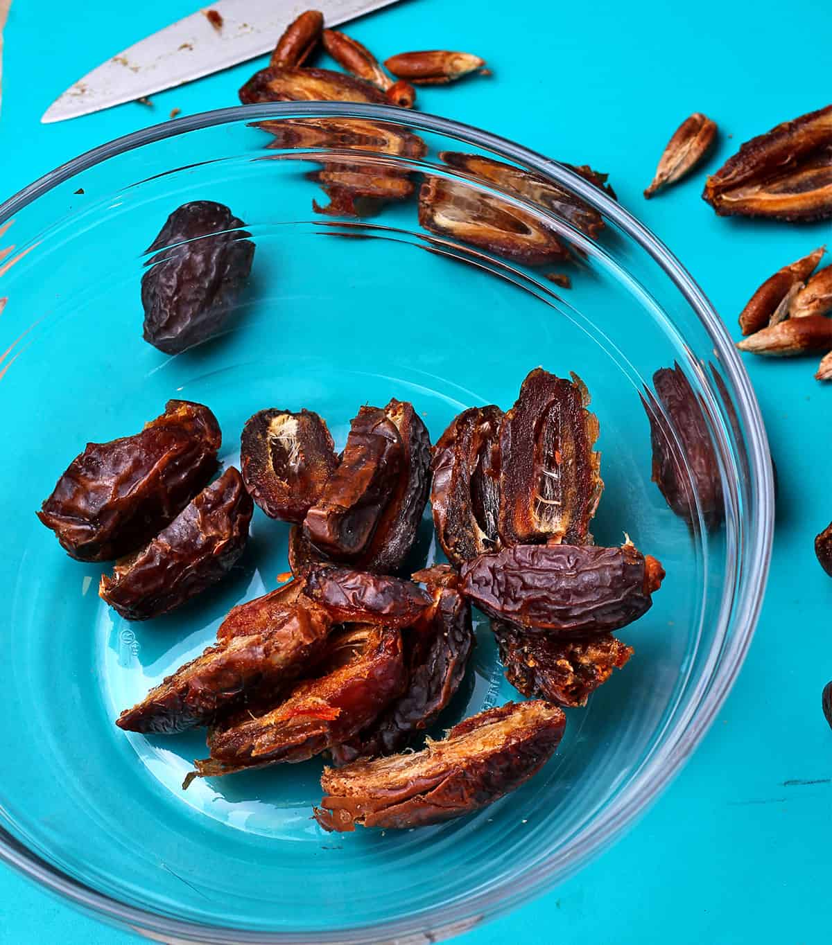 Pitted dates are placed in a glass bowl.