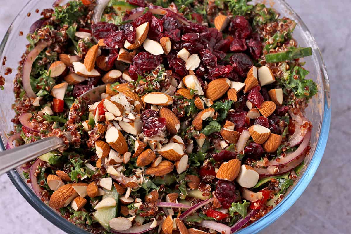 Cranberries and almonds are mixed into kale and quinoa salad.