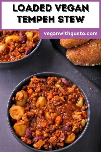 2 bowls of loaded tempeh stew with bread and a text overlay with the recipe title.