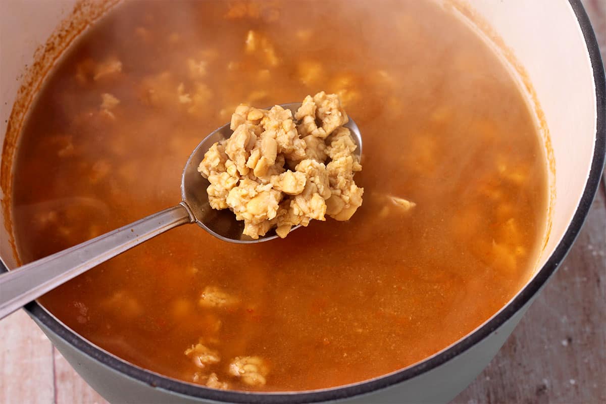 Tempeh crumbles are simmered in vegetable broth.