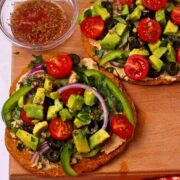 Greek flatbread pizza with veggies and hummus.