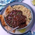 A bowl of black bean curry with rice.