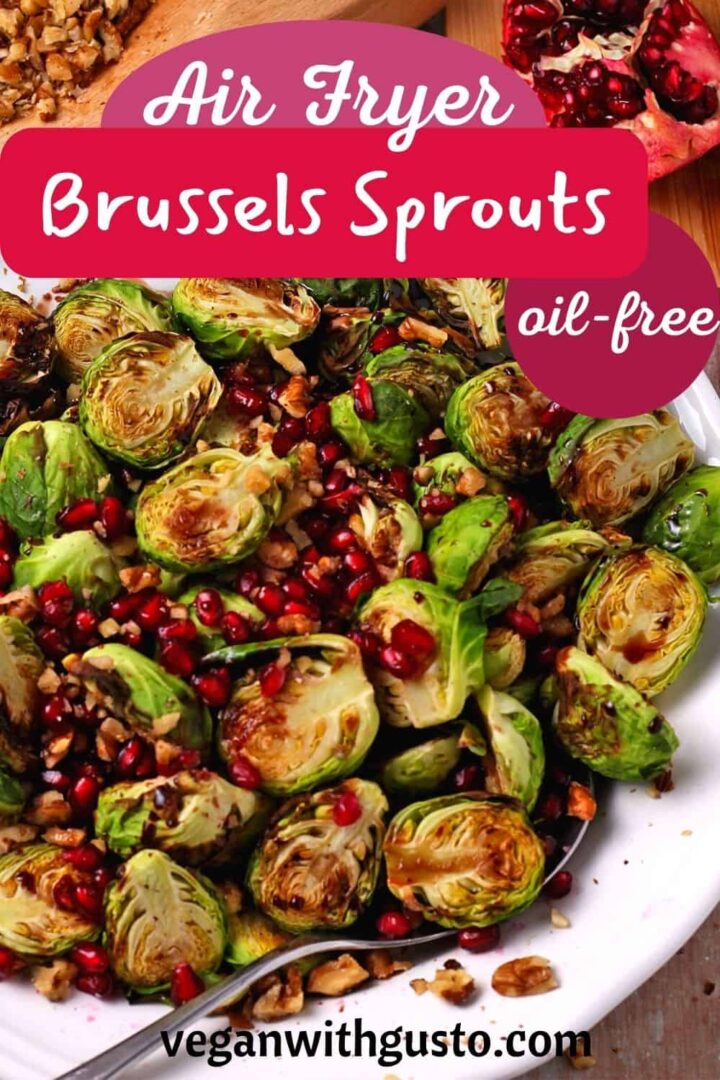 Air fried brussels sprouts with pomegranate seeds and walnuts in a white bowl.