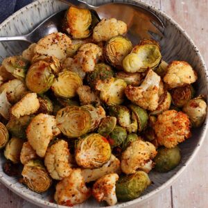 Roasted cauliflower and brussels sprouts in a bowl.