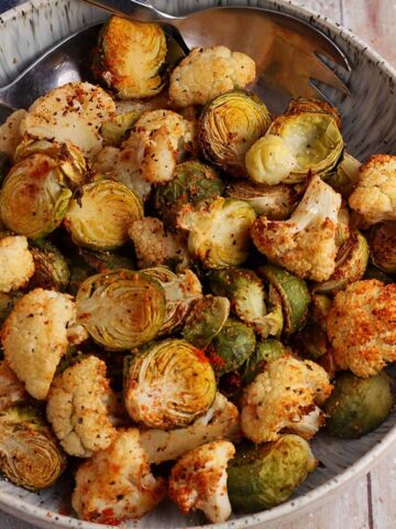 Roasted cauliflower and brussels sprouts in a bowl.