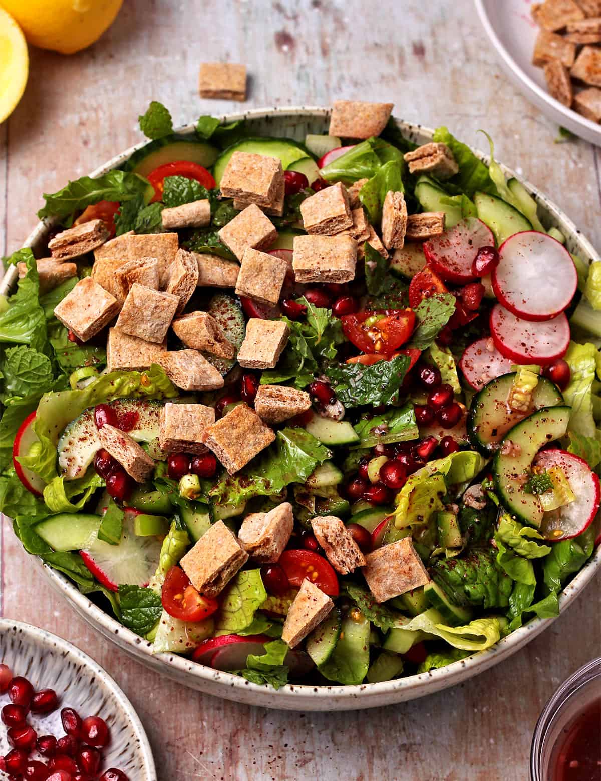 Lebanese Fattoush salad in a bowl with pomegranate seeds.