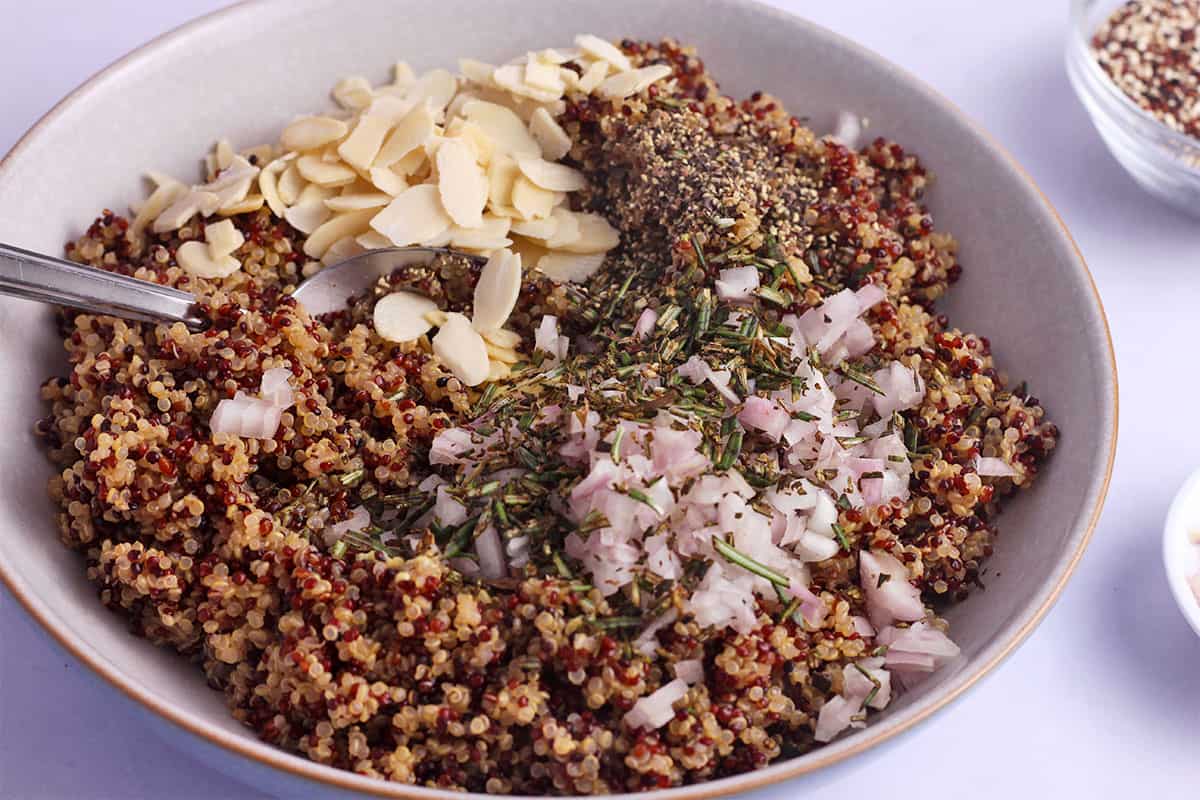 Shallots, rosemary, almonds, and black pepper is mixed with tri-color quinoa.