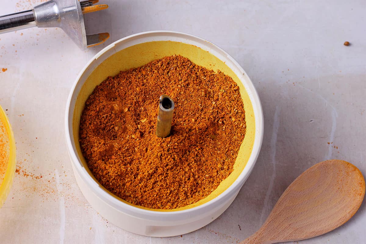Thai curry spices are ground in a spice grinder.