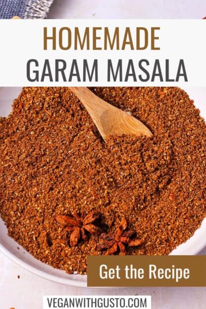 Garam masala in a dish with star anise and a small wooden spoon.