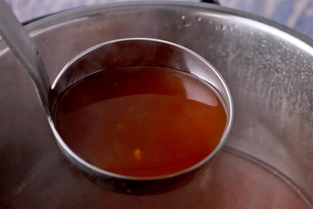 A ladle of hot and sour broth.