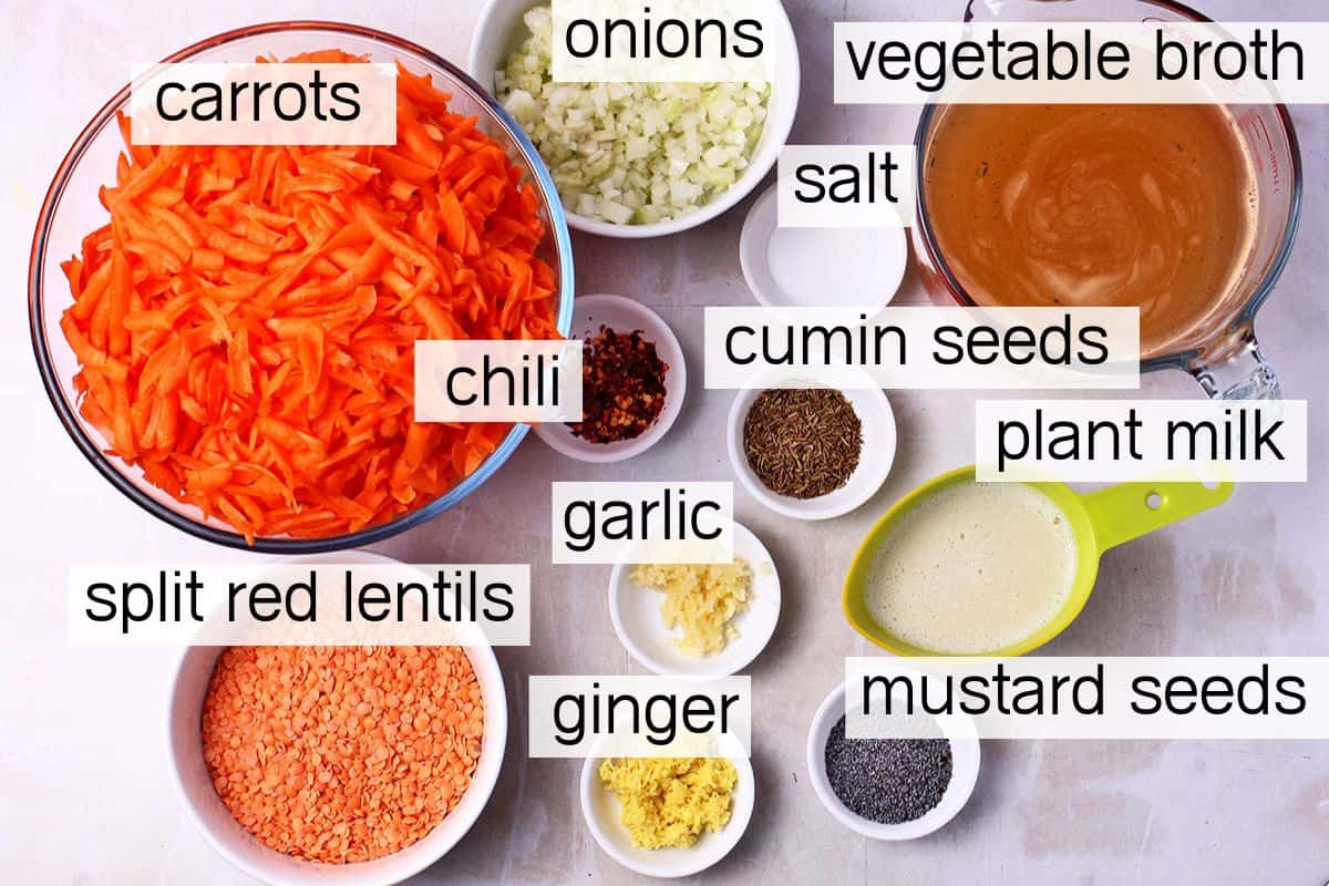 The ingredients for spiced carrot and red lentil soup with labels.