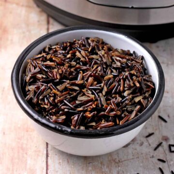 Cooked wild rice in a white bowl.