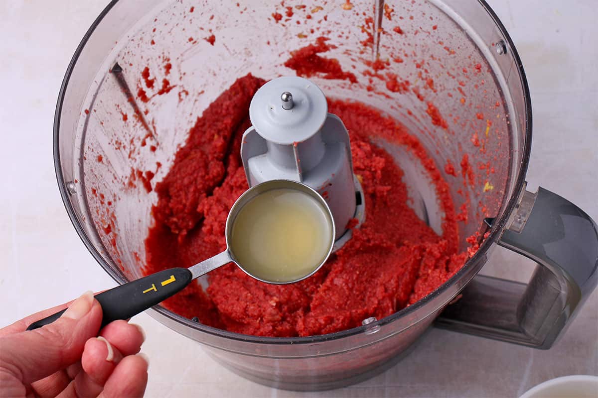 A tablespoon of aquafaba is added to blended beets and chickpeas.