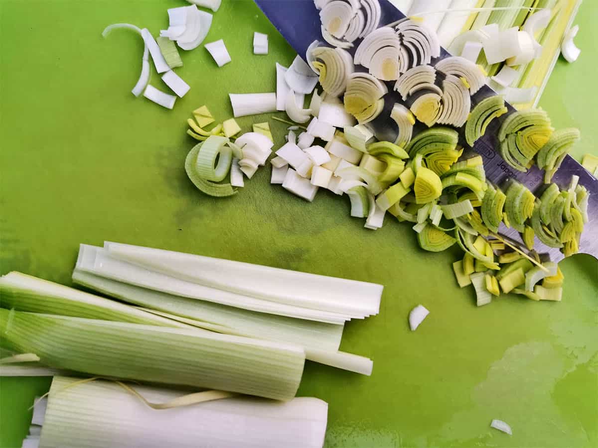 Leeks are chopped on a cutting mat.