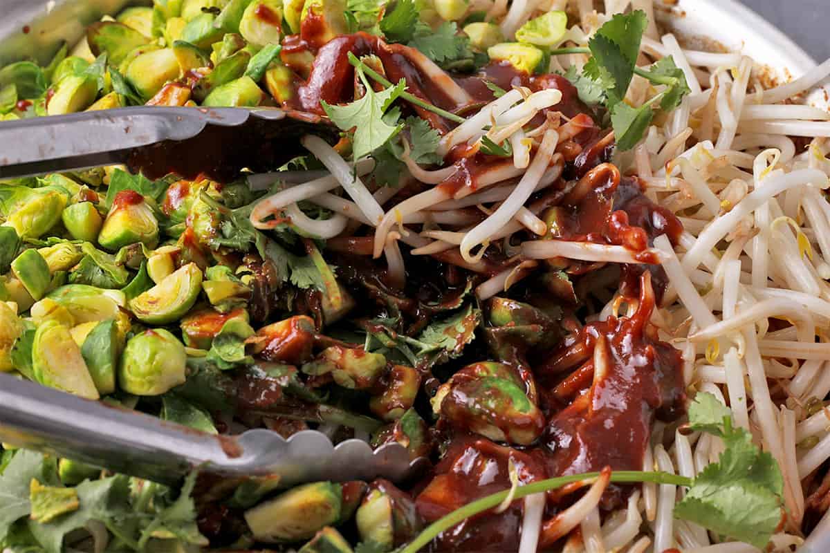 Brussels sprouts are mixed with bean sprouts, cilantro, and sauce.