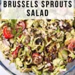 Shaved Brussels sprouts salad with vegan bacon and ranch dressing in a glass bowl with text of recipe title.