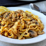 A bowl of pasta and mushroom stroganoff with tempeh.
