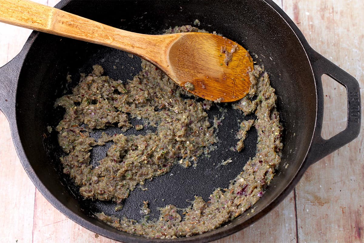 Curry paste in a black cast iron pan.